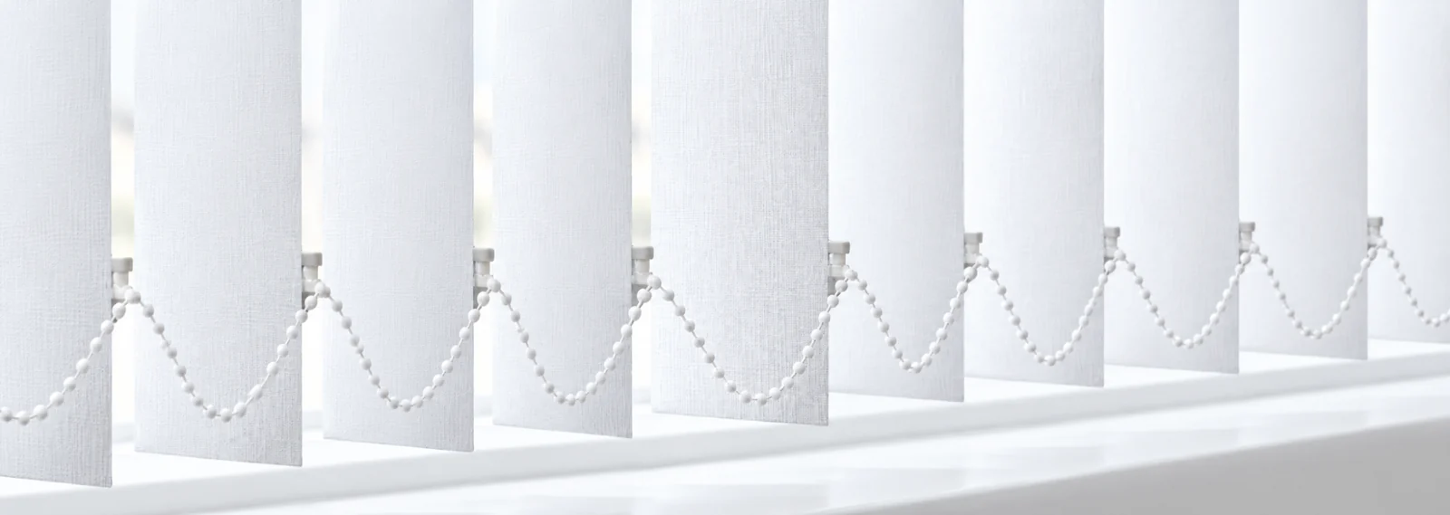 Full width display of vertical blind fabric slats with joining chain